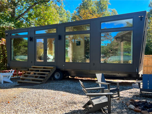 Tiny home on wheels glowing in the sunlight.